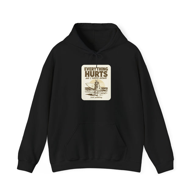 Black hoodie with a vintage-style Everything Hurts chest patch showing a surfer